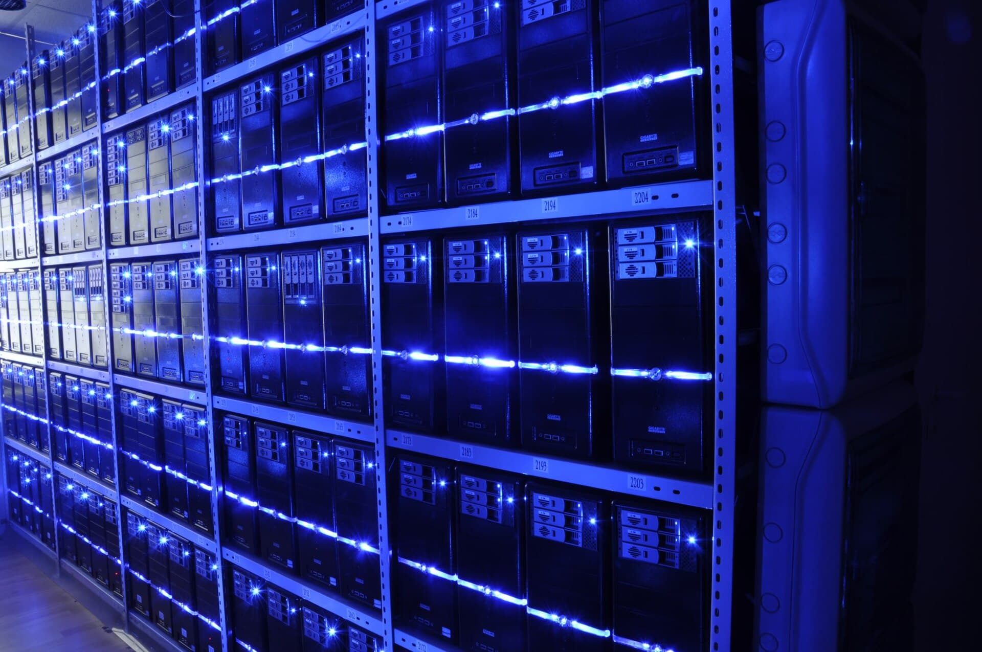 Server racks lit in blue inside a data centre